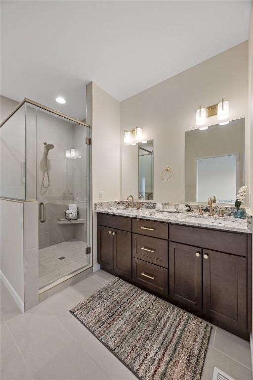 bathroom featuring vanity, an enclosed shower, and tile patterned flooring