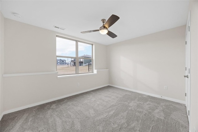 unfurnished room with light colored carpet and ceiling fan