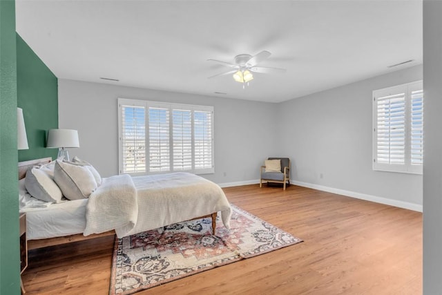 bedroom with light hardwood / wood-style flooring and ceiling fan