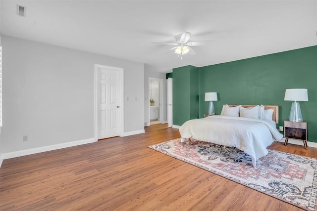 bedroom with wood-type flooring and ceiling fan