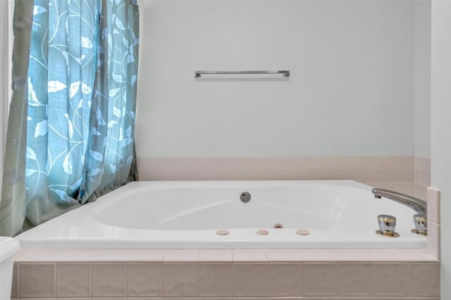 bathroom featuring a relaxing tiled tub