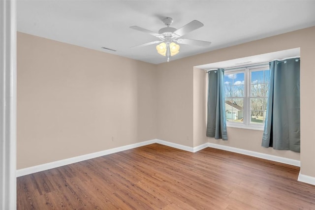 empty room with hardwood / wood-style flooring and ceiling fan