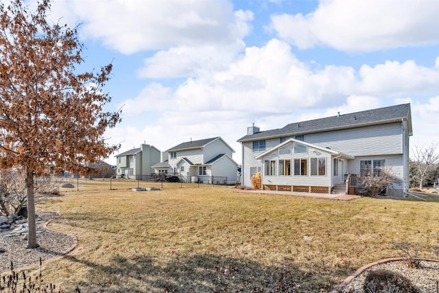 rear view of house featuring a yard