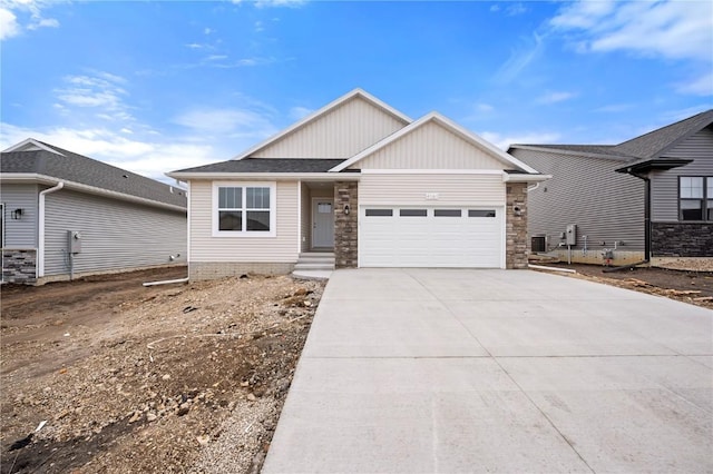 view of front of property with a garage and central air condition unit