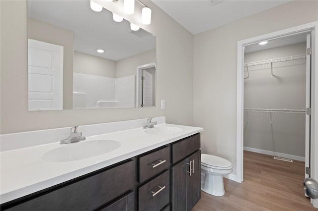 bathroom with vanity, wood-type flooring, and toilet