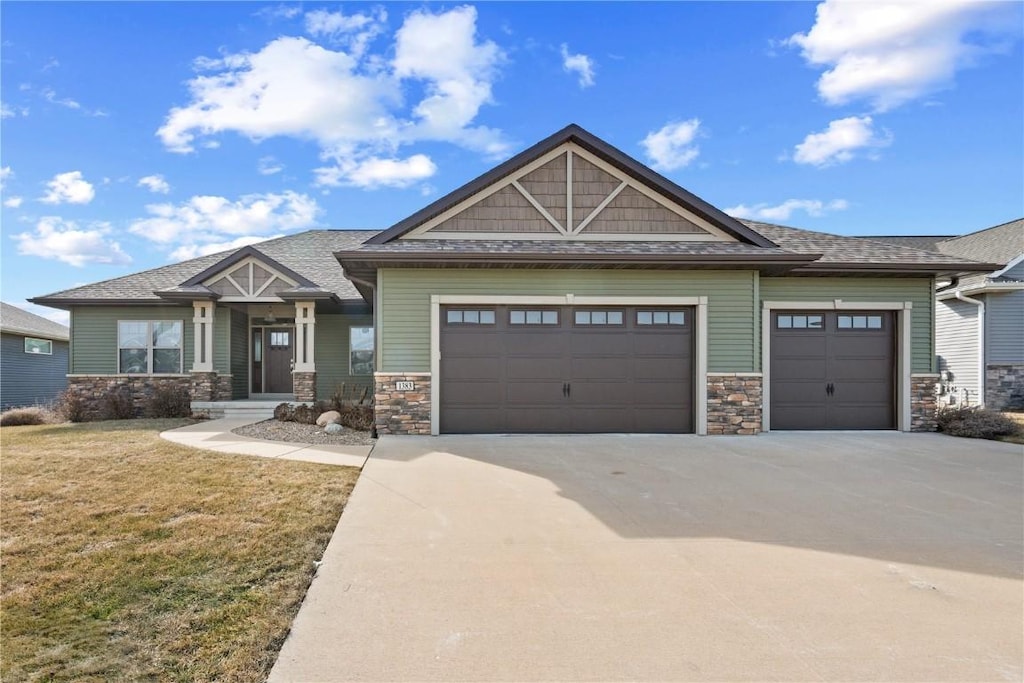 craftsman-style house featuring a garage and a front yard