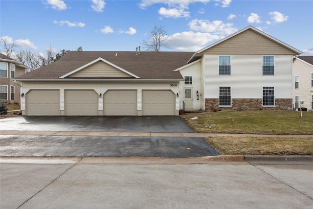 view of front facade with a garage and a front lawn