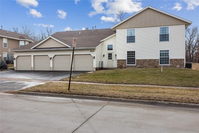 front facade featuring a garage and a front yard