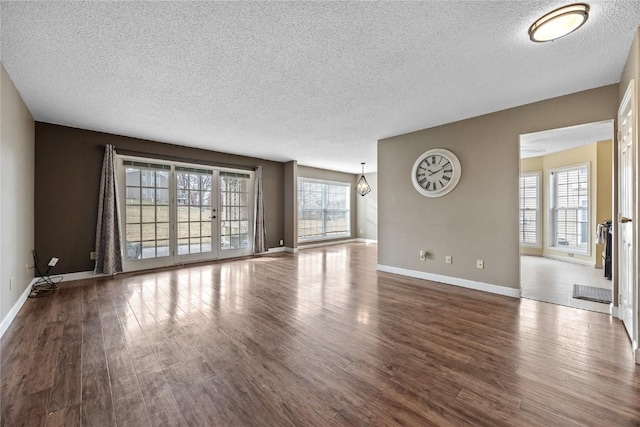 spare room featuring dark hardwood / wood-style flooring and a textured ceiling