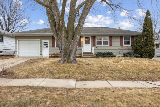 ranch-style home with a garage and a front yard