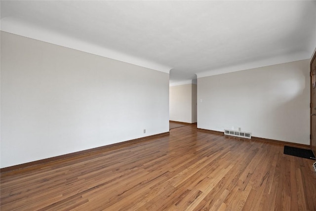 unfurnished room featuring hardwood / wood-style flooring