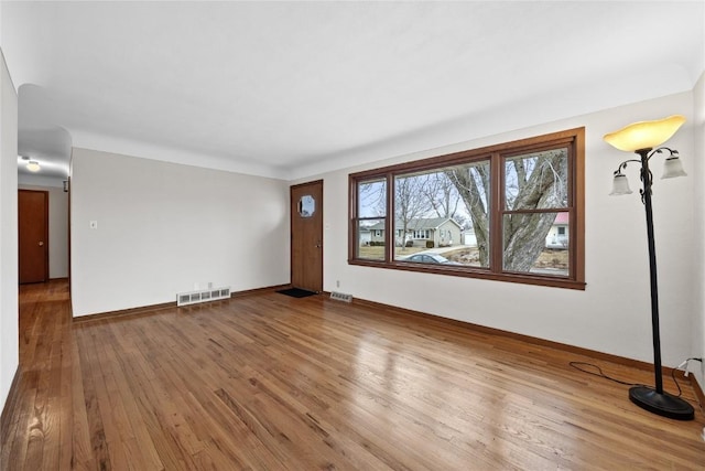 spare room with hardwood / wood-style floors