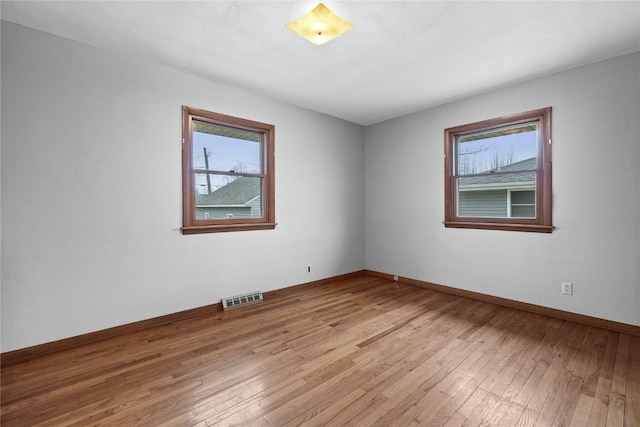 spare room with light wood-type flooring