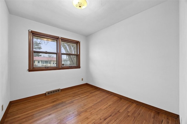 spare room with wood-type flooring