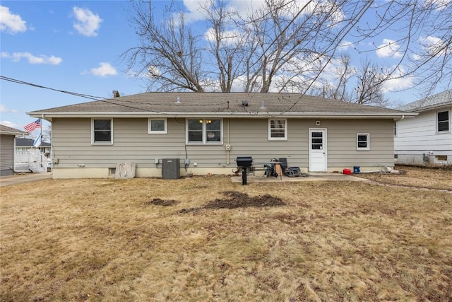 back of property featuring a lawn