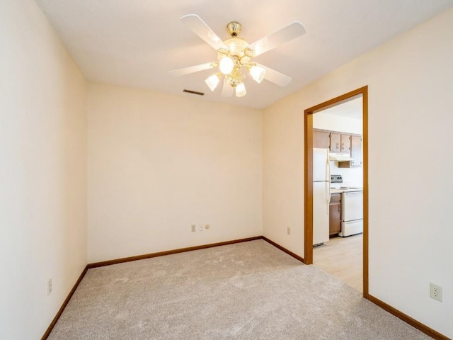 unfurnished room with light colored carpet and ceiling fan