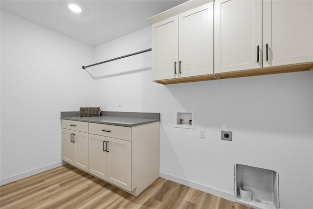 laundry area featuring cabinets, hookup for a washing machine, light hardwood / wood-style flooring, and electric dryer hookup