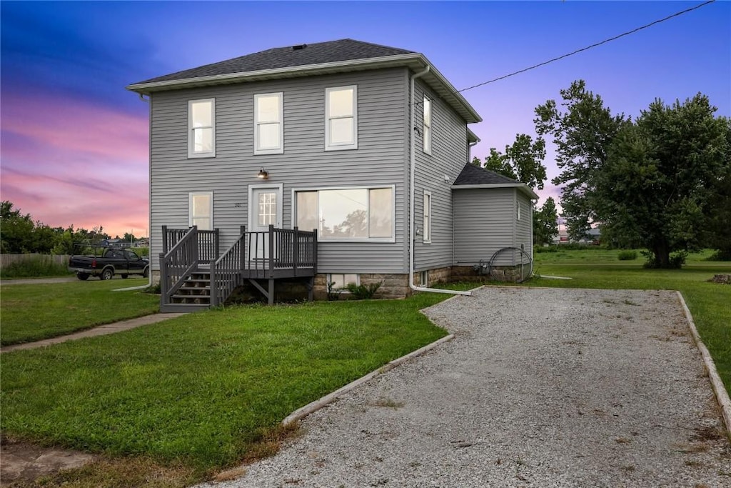 view of front of property featuring a yard and a deck