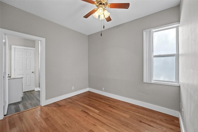 empty room featuring ceiling fan and light hardwood / wood-style floors