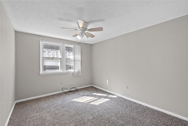 carpeted spare room with a textured ceiling and ceiling fan