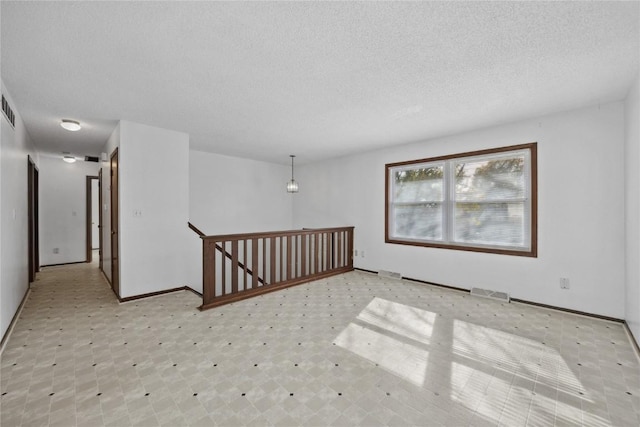 empty room with a textured ceiling