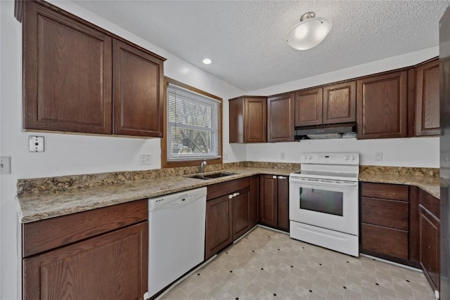 kitchen with sink, white appliances, dark brown cabinets, light stone counters, and a textured ceiling