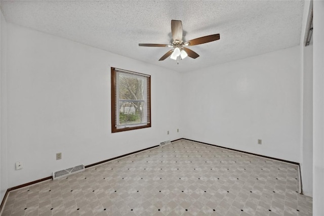 unfurnished room featuring ceiling fan and a textured ceiling