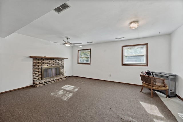 unfurnished living room with a fireplace, ceiling fan, and carpet