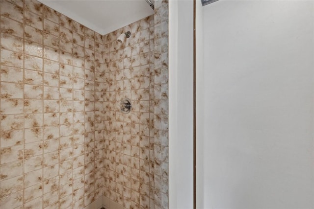 bathroom with a tile shower