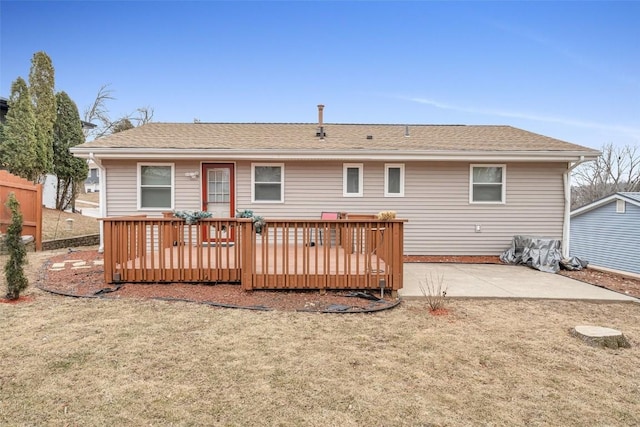 back of house with a wooden deck, a patio area, and a lawn