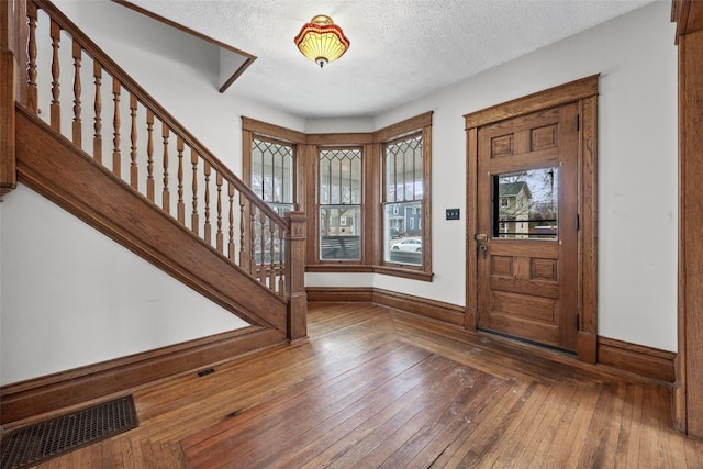 entrance foyer featuring dark wood-type flooring and a textured ceiling