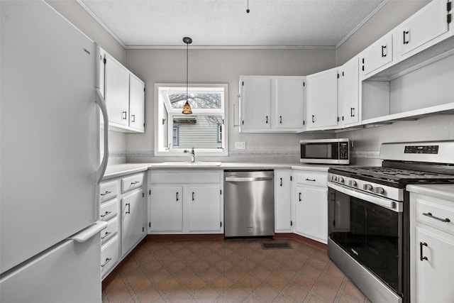 kitchen featuring white cabinetry, sink, hanging light fixtures, stainless steel appliances, and a textured ceiling