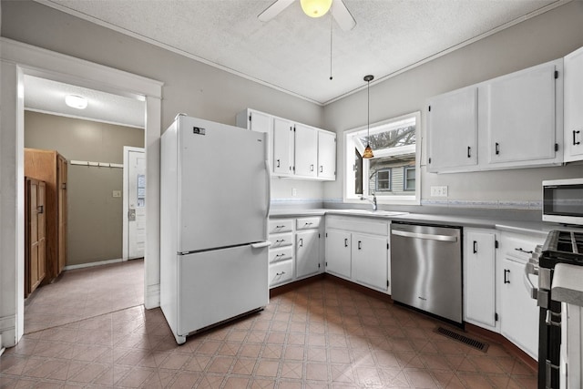 kitchen with white cabinetry, a textured ceiling, ceiling fan, and appliances with stainless steel finishes