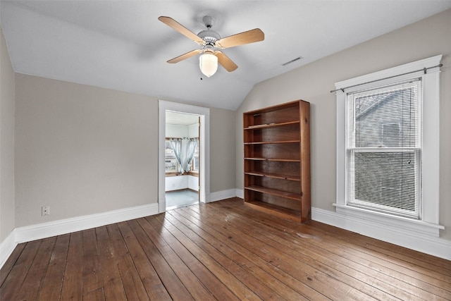 spare room with hardwood / wood-style flooring, ceiling fan, and vaulted ceiling