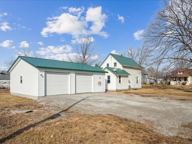 view of front of home with a garage and an outdoor structure