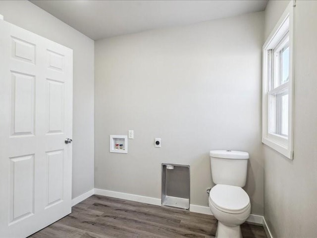 bathroom with toilet and hardwood / wood-style floors