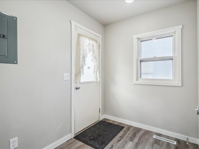 foyer entrance with hardwood / wood-style floors and electric panel