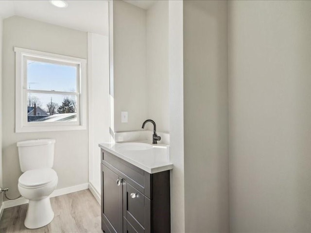 bathroom featuring hardwood / wood-style flooring, vanity, and toilet