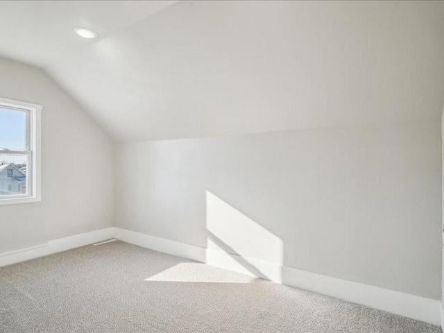 additional living space with lofted ceiling and carpet floors