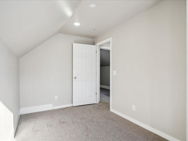 additional living space with lofted ceiling and carpet floors