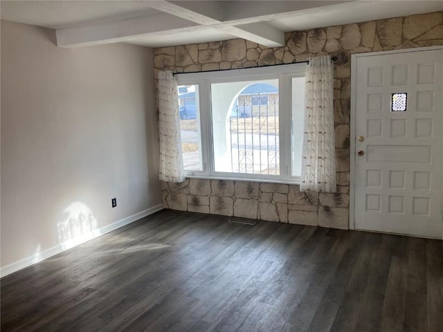 entryway with beam ceiling and dark hardwood / wood-style flooring