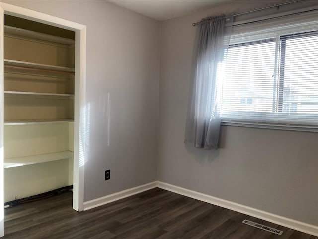 unfurnished room featuring dark hardwood / wood-style floors