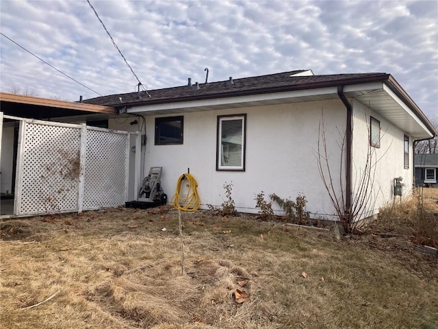 rear view of property with a lawn