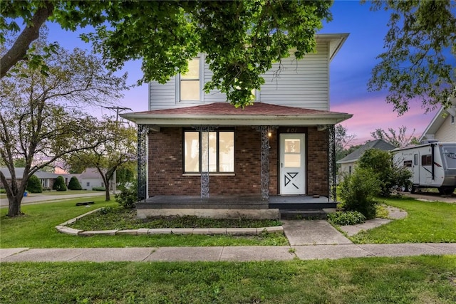 view of front of home featuring a yard and covered porch