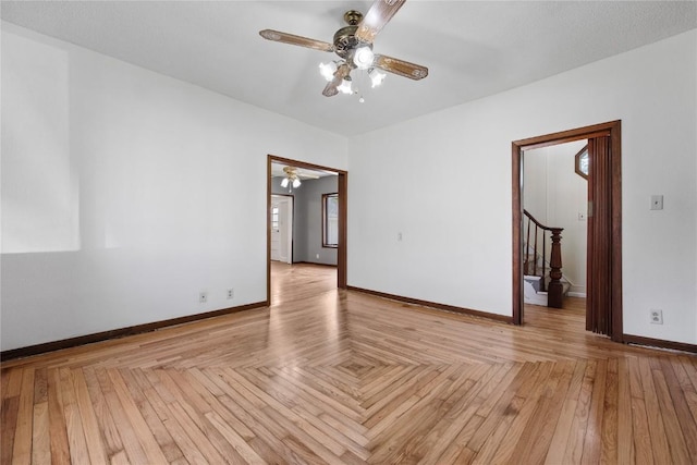 spare room featuring light parquet flooring and ceiling fan