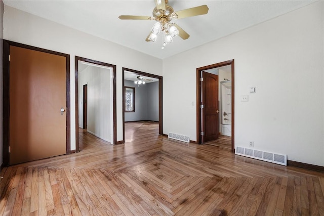 interior space with parquet floors and ceiling fan