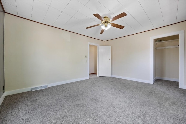 unfurnished bedroom featuring ceiling fan, ornamental molding, and carpet floors