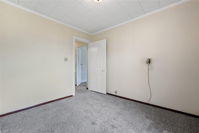 carpeted spare room with crown molding