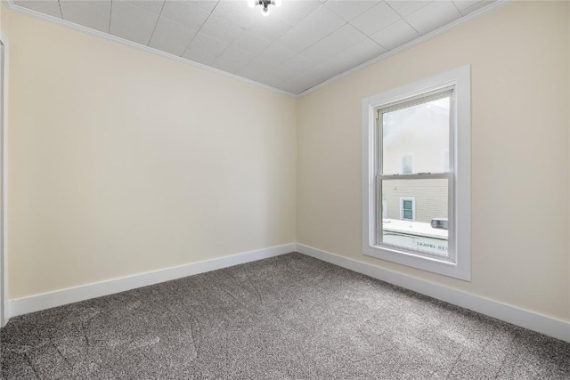 carpeted spare room with crown molding