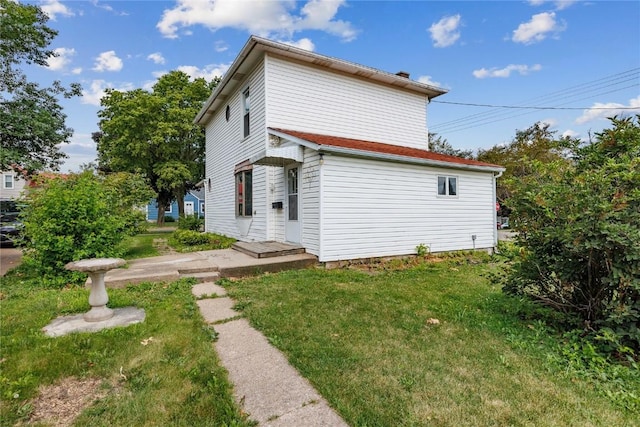 back of house with a lawn